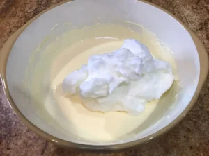 Add whipped egg whites to the classic cheesecake mixture