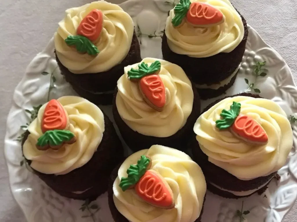 Mini Moist Carrot Cake decorated with piped frosting and decorated with carrot cookies