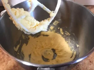 Butter being beaten in a stand mixer until light and creamy for butter icing