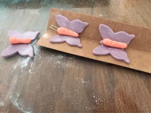 Gum paste butterflies shaped with raised wings and left to dry.