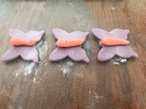 Attaching the gum paste thorax to the butterfly using Tylose glue.