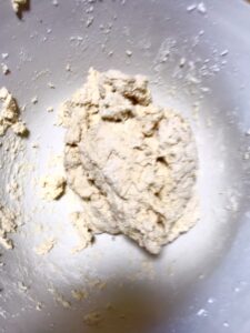 Crumble together butter, milk, baking powder and flour