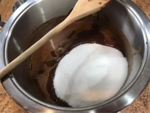 Granulated sugar added to melted chocolate mixture for brownies