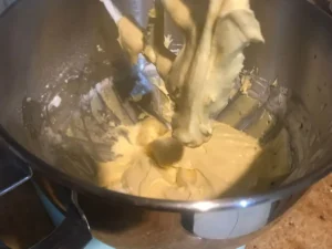 Slowly folding flour, cornflour, and baking powder into Frankfurter Kranz batter
