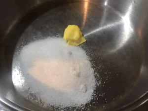 utter and sugar melting in a pan for almond brittle