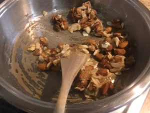 Almonds stirred into melted sugar and butter mixture