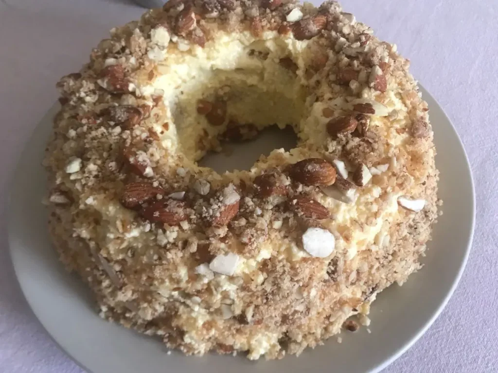 Finished Frankfurter Kranz cake coated with buttercream and topped with almond brittle