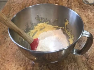 Adding the dry ingredients to the cake batter for the apple cinnamon loaf