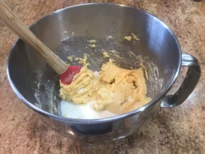 Adding milk to the apple cinnamon cake batter