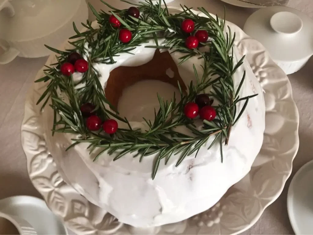 Christmas wreath cake decorated with royal icing, greenery and fake berries