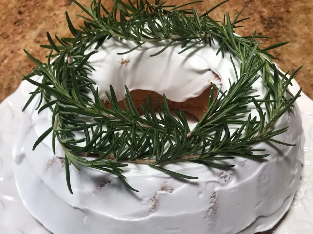 Yoghurt cake iced with royal icing and decorated with greenery