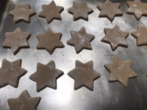 Zimtsterne - roll and cut out stars and place them on a lined baking tray