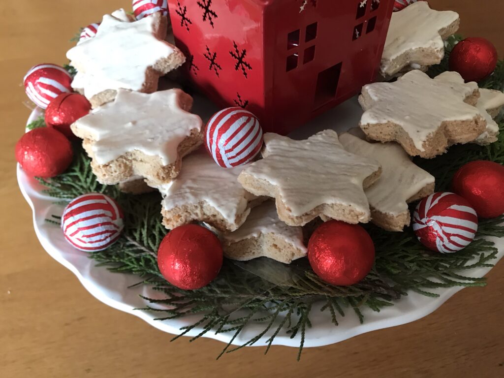 Plated German Cinnamon Stars with chocolate balls and a Christmas House Centrepiece