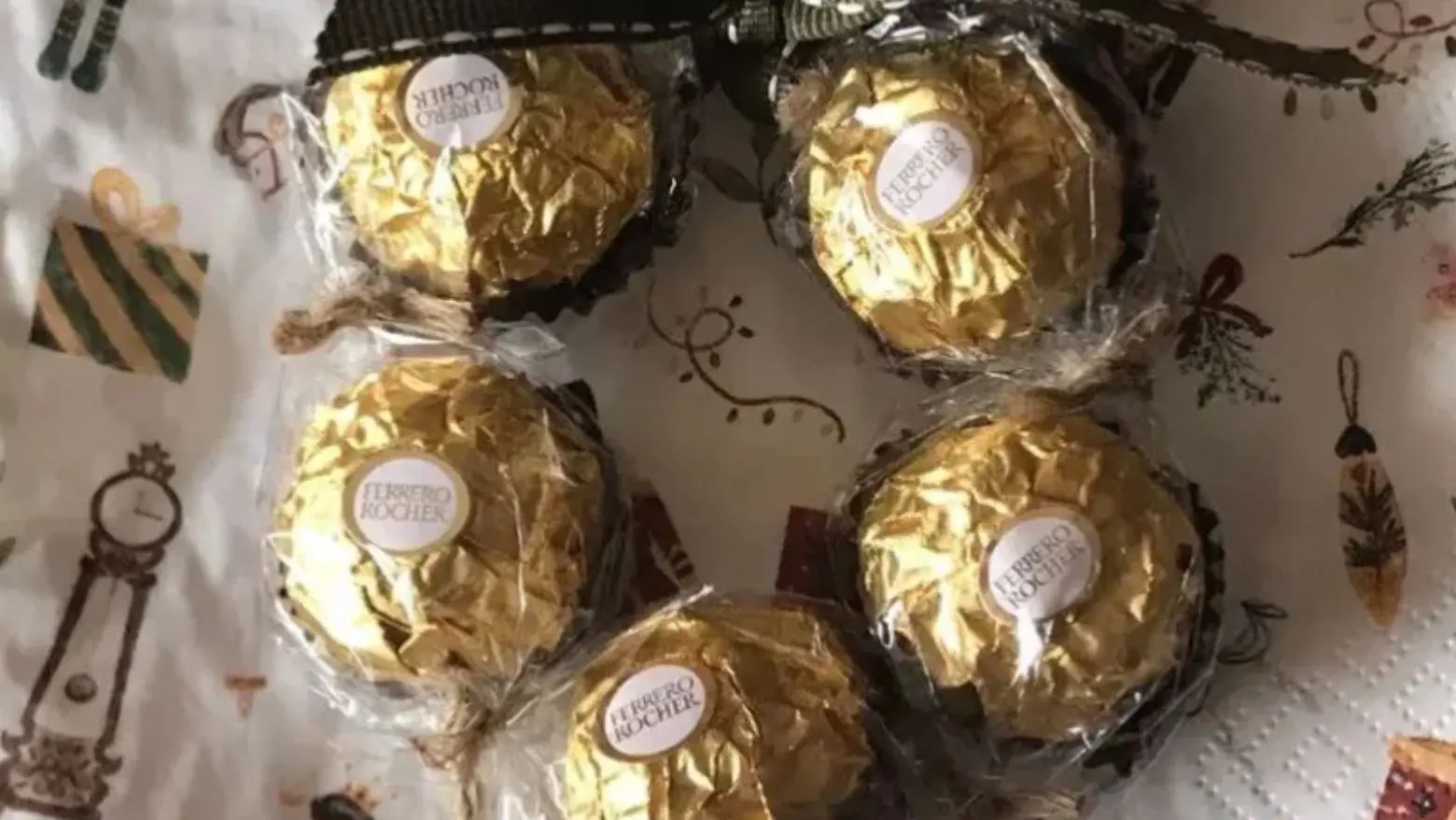 A small Ferrero Rocher wreath tied with a green ribbon.