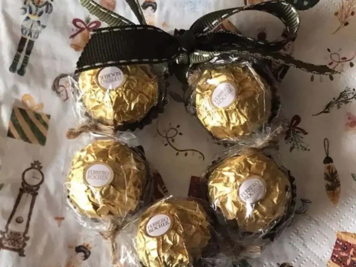 A small Ferrero Rocher wreath tied with a green ribbon.