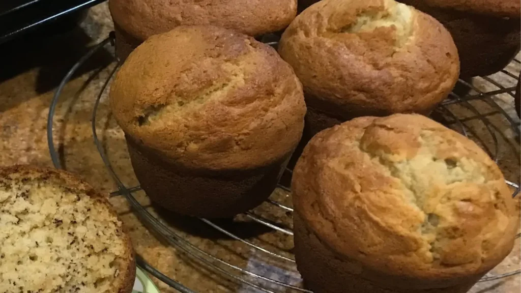 Homemade banana muffins cooling on a wire rack, golden and fluffy