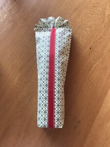 DIY Bottle Gift Wrapping - Wrap a ribbon around the bag.