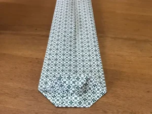 Folding wrapping paper to create the base of a bottle gift wrap