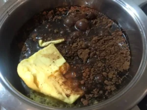 Butter, cocoa, oil and water combined in a bowl for the Easter Chocolate Cake batter.