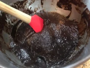 Thick chocolate cake batter being folded together