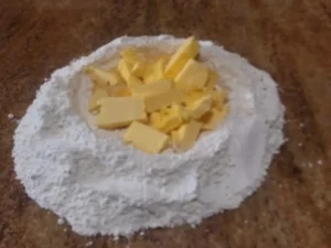 Cubed butter added to flour mixture for German tea biscuits