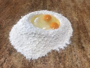 German Tea Biscuits - Create a well in the centre and add the granulated sugar, vanilla sugar, and eggs.