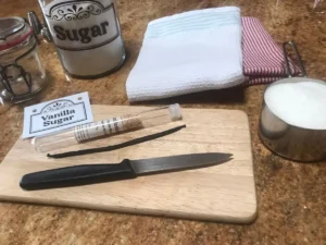 Knife and vanilla pod on a wooden board for making homemade vanilla sugar