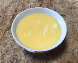 Melted butter and milk mixture in a white bowl