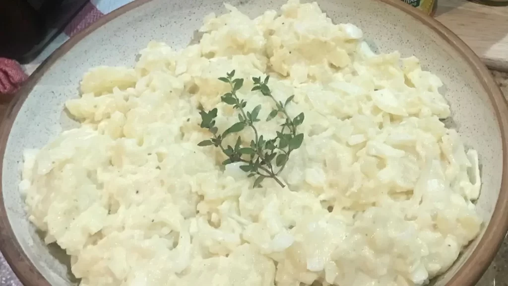 Creamy warm potato salad in a bowl