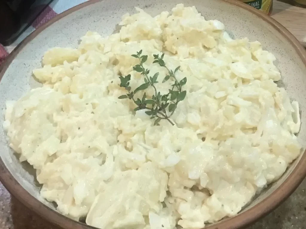 Creamy warm potato salad in a bowl
