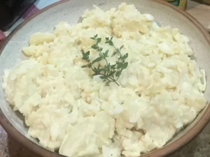 Creamy warm potato salad in a bowl