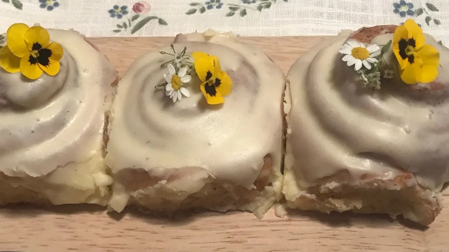 Iced cinnamon roll decorated with flowers