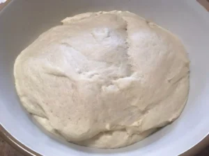 Cinnamon roll dough after the first rise, doubled in size.