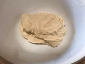 Smooth, kneaded cinnamon roll dough ready for first rise.
