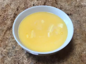 Melted butter and milk mixture in a white bowl