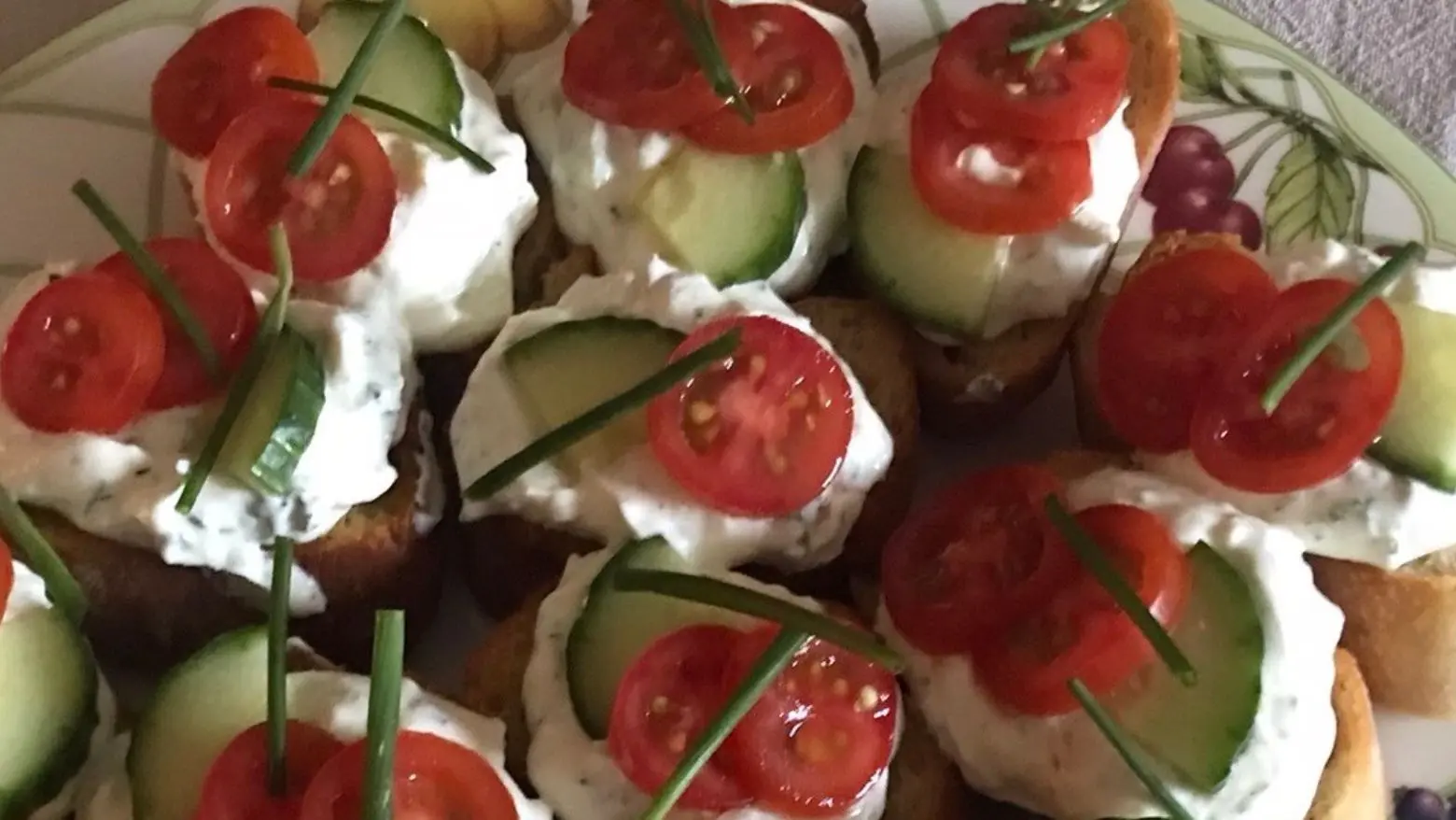 Garlic and Herbs Cottage cheese served on baguette garnished with tomatoes cucumber and chives