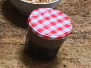 Homemade sweet and tangy dressing for crunchy cabbage salad in a glass jar