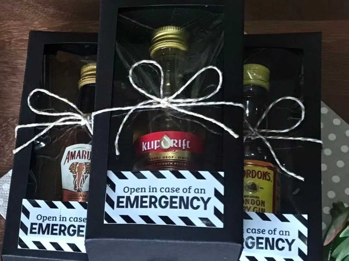 “In Case of Emergency” mini alcohol bottles displayed in a black gift box for party favours.