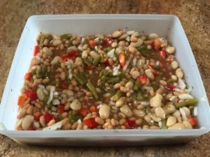 Three bean salad in a rectangular container.