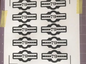 Printed chocolate cigar labels laid out on a sheet, designed for DIY chocolate cigar party favours