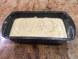 Old fashioned banana bread batter in loaf tin before baking