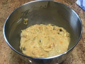Russian squares recipe batter mixed with dried fruit in a bowl