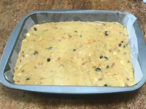 Russian squares recipe batter spread evenly into a baking tin