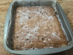 Russian squares recipe baked in a rectangular tray with sugar topping