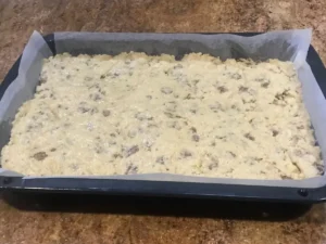 Unbaked buttermilk bran rusk mixture in a roasting tin