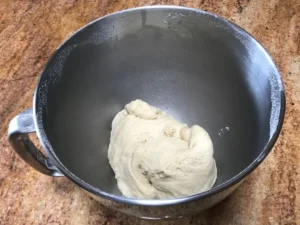 Kneaded Butterkuchen dough inside a stand mixer bowl.