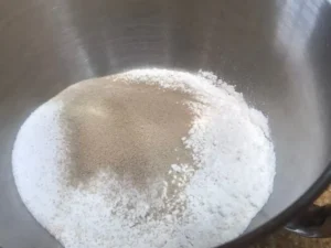 Dry ingredients in a stand mixer bowl for Butterkuchen dough.