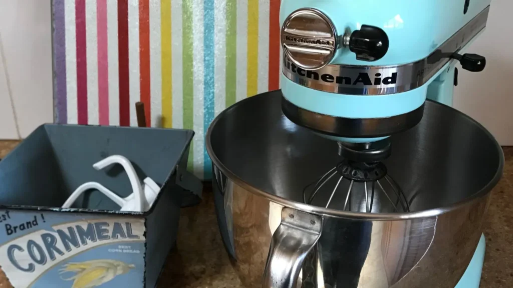 KitchenAid stand mixer with stainless steel bowl and whisk attachment