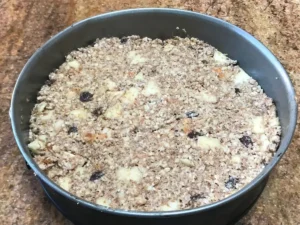 Unbaked oats and apple breakfast cake mixture in baking tin