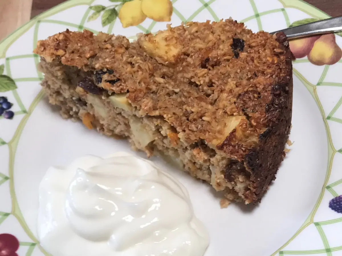 Slice of oats and apple breakfast cake served with yoghurt